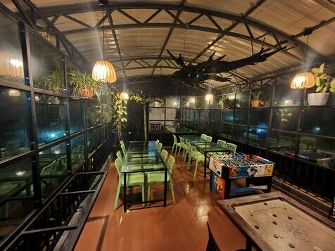 "Elegant restaurant at Vintage Garden Resort in Wayanad offering a cozy dining experience with scenic views."